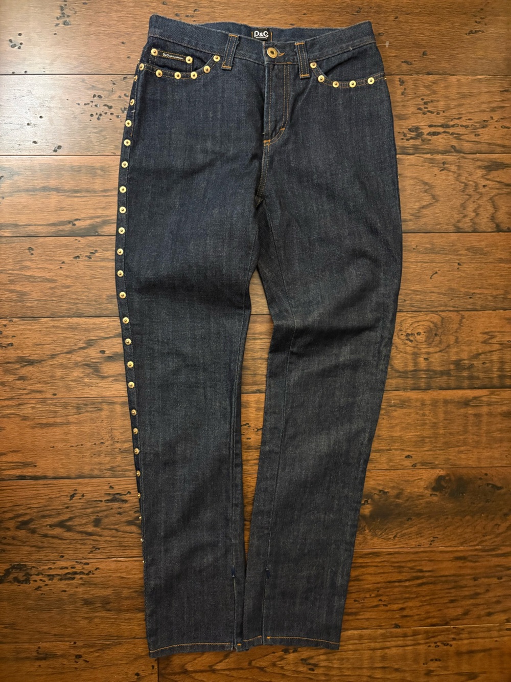 Dolce and Gabbana dark jeans with gold rivets